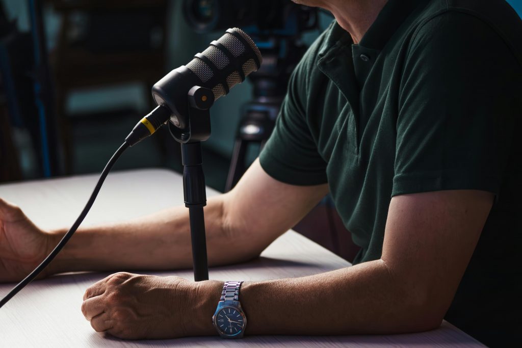 Man Speaking into Microphone for Podcast or Recording